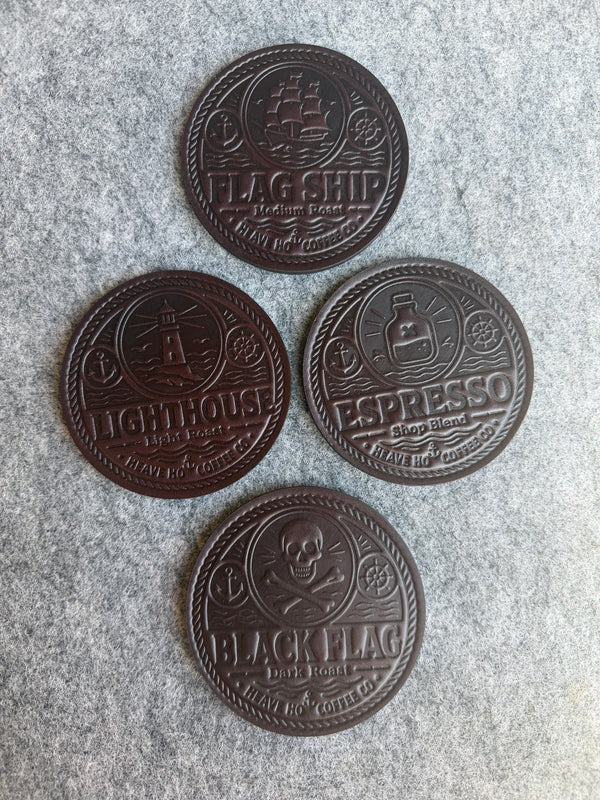 Four custom embossed leather coaster designs created for Heave Ho Coffee Co.