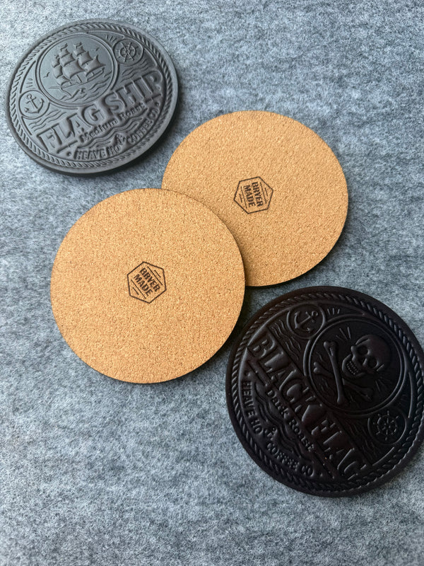 Cork backs of custom leather coasters with Bryer Made maker marks